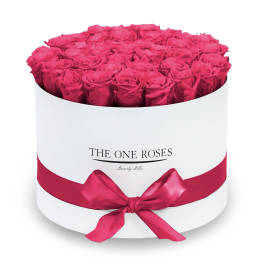 Round box of hot pink roses with a satin ribbon
