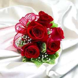 Bouquet of red roses with pink ribbon and white filler flowers