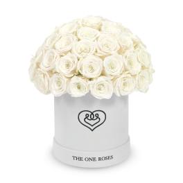 White roses arranged in a round hatbox with a heart logo