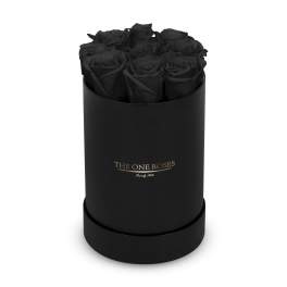 Black roses arranged in a round black box