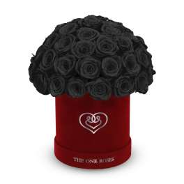 Black roses in a red velvet hat box with a heart emblem