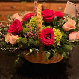 Basket arrangement with red and blush roses