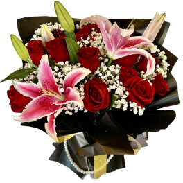 Bouquet of red roses and pink lilies wrapped in black paper