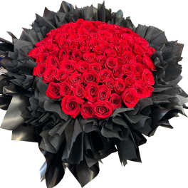 Large bouquet of red roses wrapped in black paper