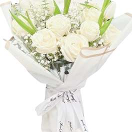 White roses and tulips in a wrapped bouquet