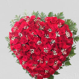 Heart-shaped bouquet of red roses with baby's breath