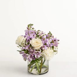 Lavender and white bouquet in a clear glass vase
