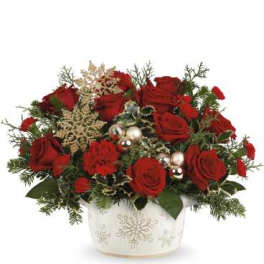 Red roses arranged in a white snowflake vase