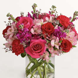 Pink and red rose bouquet in a clear glass vase
