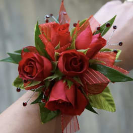 Red rose wrist corsage with ribbon and bead accents