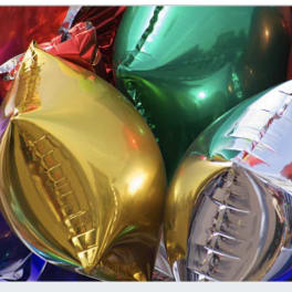 Cluster of shiny metallic balloons in red, gold, blue, green, and silver