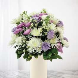 Lavender and white mixed bouquet in a cream vase
