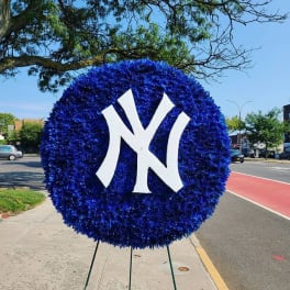 Large blue floral wreath with a white interlocking "NY" logo