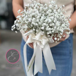 White baby's breath bouquet tied with a satin ribbon