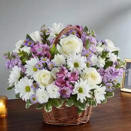 Basket of white and purple flowers with roses and daisies