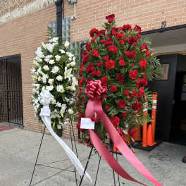 Two standing floral sprays with red and white flowers on easels