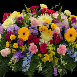 Bright mixed sympathy spray with roses, gerbera daisies, carnations, and mums