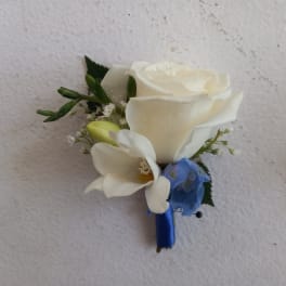 White rose boutonniere with a blue ribbon wrap