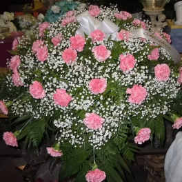 Large pink carnation funeral spray with baby's breath