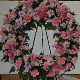 Pink and lavender floral wreath on a stand