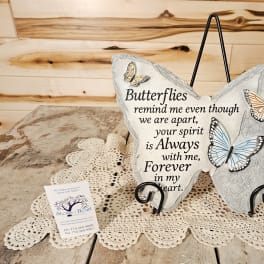 Butterfly-shaped memorial plaque with a sympathy message