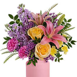 Pink and purple bouquet with lilies and roses in a pink vase