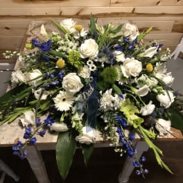 Large white and blue floral spray with roses and lilies