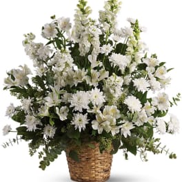 White flower arrangement in a woven basket