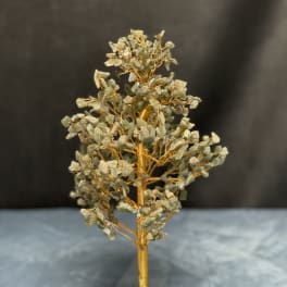 Gemstone tree sculpture with gold wire branches on a green stone base