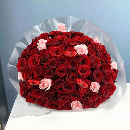 Bouquet of red and pink roses with small red heart decorations
