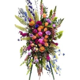Tall colorful floral spray with mixed blooms on a white background