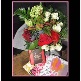 Bouquet of red and white flowers with a chocolate box and greeting cards