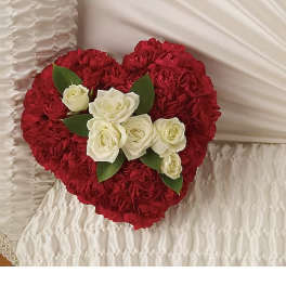 Heart-shaped red rose arrangement with white roses in the center