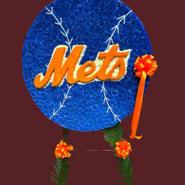 Mets-themed floral tribute with a blue circular sign and orange ribbon accents
