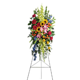 Tall standing floral spray with mixed bright flowers on an easel