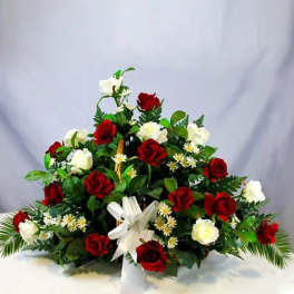 Red and white rose arrangement with a white ribbon bow