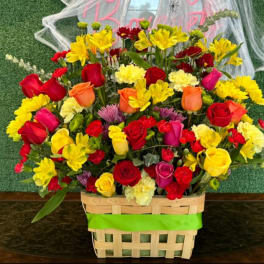 Basket arrangement of red, yellow, and orange flowers