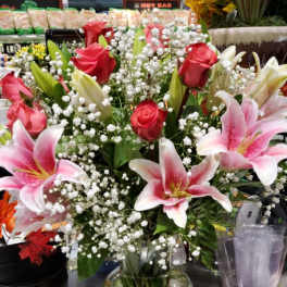 Bouquet of pink roses and pink lilies in a glass vase