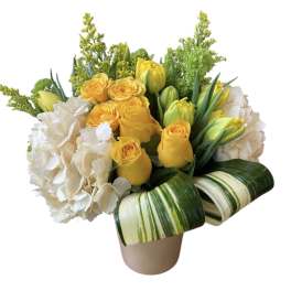 Yellow roses and white hydrangeas in a beige vase with striped leaves