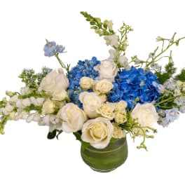 Blue hydrangeas and white roses in a green vase