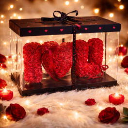 Red rose arrangement spelling "I LOVE U" in a clear gift box