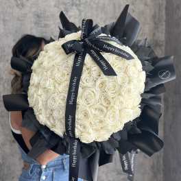 Large bouquet of white roses wrapped with black ribbon