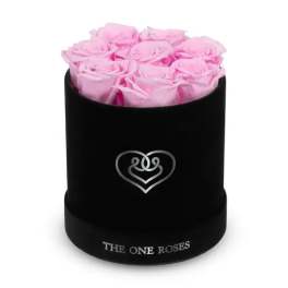 Pink roses arranged in a black round box