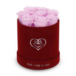Pink roses in a red velvet hat box with a heart emblem
