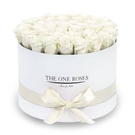 White roses arranged in a round white box with a ribbon bow