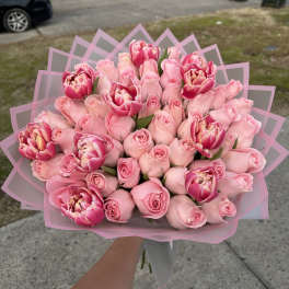 Bouquet of pink roses and pink tulips wrapped in pink paper