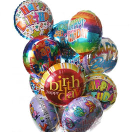 Cluster of colorful birthday balloons with printed messages