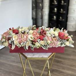 Long floral box arrangement with roses, hydrangeas, and pomegranates
