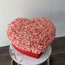 Heart-shaped box filled with pink roses