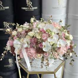 Large pastel bouquet of roses, orchids, and hydrangeas in a white hatbox